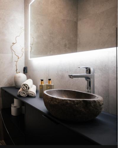 a bathroom sink with a large stone bowl at Luxurious Rakka Suites, Ylläs in Äkäslompolo