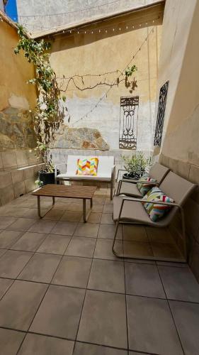 a patio with two couches and a table at Ca La Abuela in Requena