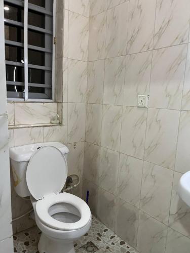 a bathroom with a white toilet and a sink at 3 bedroom Apartment lekki Victory Homes in Mama