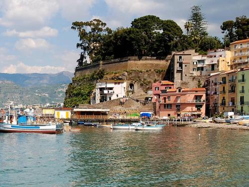 a group of boats in the water next to buildings at Garghe House in Sorrento