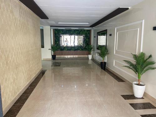 a hallway with potted plants in a building at Panorama Apartment Nador Jadid Klima Parking Only Family in Nador