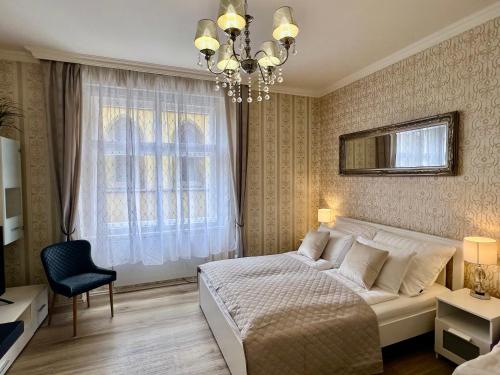 a bedroom with a white bed and a chandelier at Romance in the Old Town in Prague