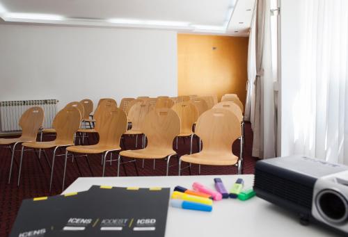 an empty conference room with chairs and a projector at Hotel Hayat in Sarajevo