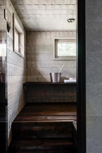 a tiny house with a sink in the bathroom at Himos Stonelake - two saunas and a hot tub in Jämsä