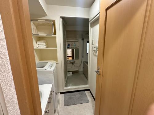 a small bathroom with a washer and dryer in it at Sunshine Grand Hotel Ikebukuro in Tokyo