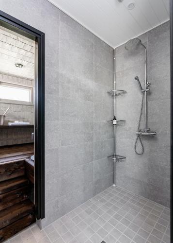 a shower stall in a bathroom with a shower at Himos Stonelake - two saunas and a hot tub in Jämsä