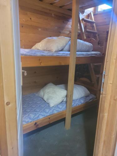 a room with three bunk beds with pillows at Appartement Pyrénées 2000 in Bolquere Pyrenees 2000
