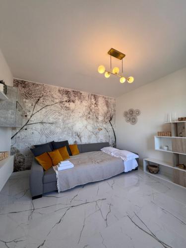 a bedroom with a bed and a stone wall at Garda Lake Holiday Apartments Trilocale in Cavalcaselle