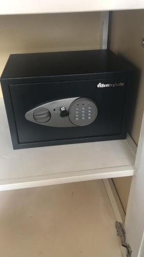 a black box with a remote control sitting on a shelf at Upstairs 3 Bedroom Avalon Regia Apartment in Georgetown
