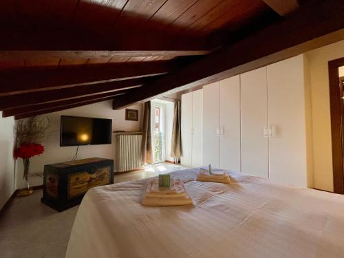 a bedroom with a bed with two wooden blocks on it at Il Girasole in Mandello del Lario