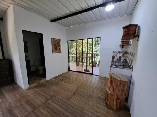 a room with white walls and a wooden floor at Cabaña sol wifi jacuzzi charcos parking in Barbosa