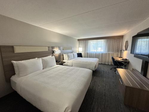a hotel room with two beds and a television at Best Western Plus Downtown Tacoma in Tacoma