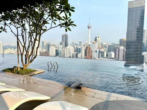 a swimming pool with a view of a city at Luxury Axon Residence Bukit Bintang KLCC PAVILION By IZ in Kuala Lumpur