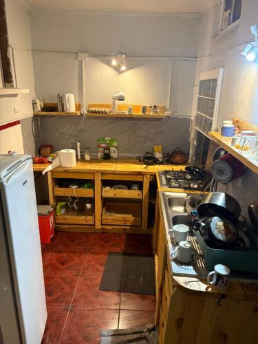 a kitchen with a stove and a counter top at BbCasita Yellow in Valparaíso