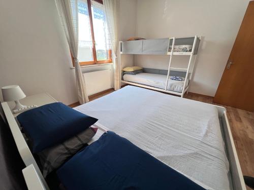a bedroom with two beds and a bunk bed at Villa Gianfranca - sentiti come a casa in Corno di Rosazzo