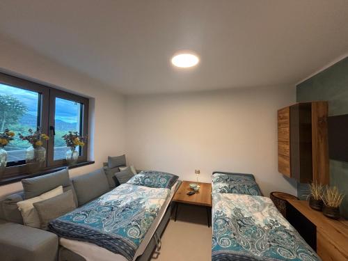 a living room with two beds and a couch at Apartment Wörtherseeliebe in Pörtschach am Wörthersee