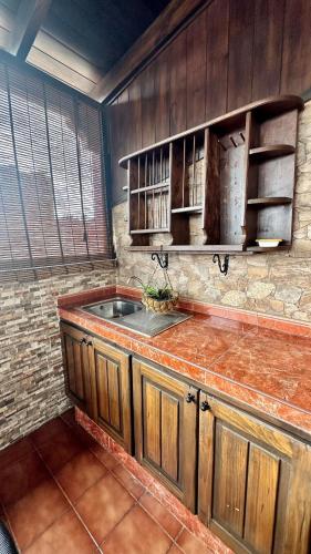 a kitchen with a sink and a brick wall at Relaxing Villa Las Torres in Adeje