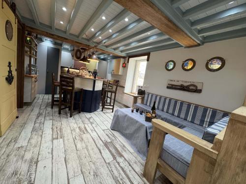 a living room with a couch and a kitchen at Riva Bella Marine in Ouistreham