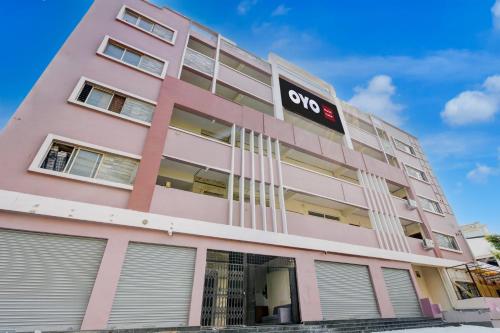 a pink building with a soo sign on it at FabHotel Cube in Maula Ali