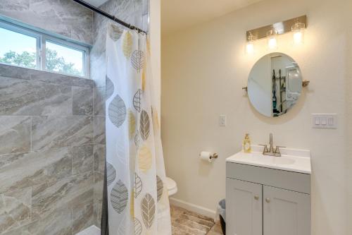a bathroom with a shower and a sink and a mirror at Mtn-View Cottage with Garden and Yard in Erwin! in Erwin