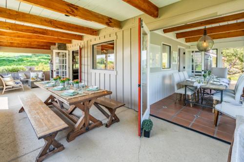 a porch with a wooden table on a house at Ballard Canyon Ranch by Paradise Retreats in Solvang