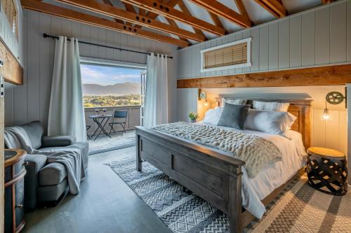 a bedroom with a large bed and a balcony at Ballard Canyon Ranch by Paradise Retreats in Solvang
