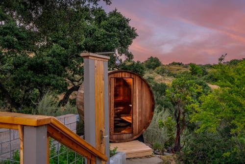 a wooden circle house on a deck with a tree at Ballard Canyon Ranch by Paradise Retreats in Solvang