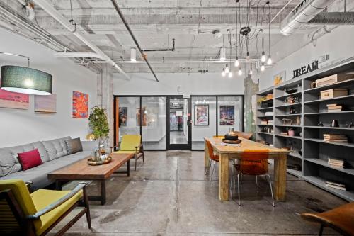 a living room with a couch and tables and chairs at Chic Escape 710 2bd Sleeps 12 Free Parking in Dallas