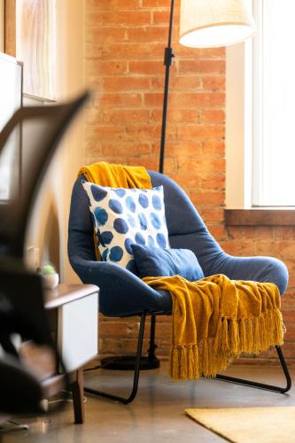 a blue chair with a blanket on it in a living room at Chic Escape 710 2bd Sleeps 12 Free Parking in Dallas