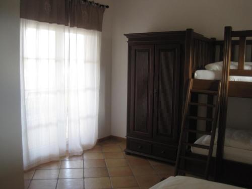 a bedroom with a bunk bed and a window at Appartements Vanii in Rust