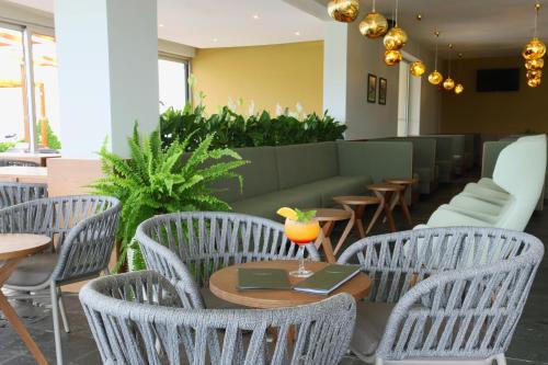 a restaurant with chairs and a table with a drink on it at Agua Hotels Mondim de Basto in Mondim de Basto