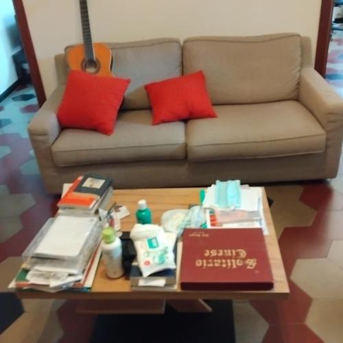 a living room with a couch and a coffee table at camera vacanza in Celle Ligure