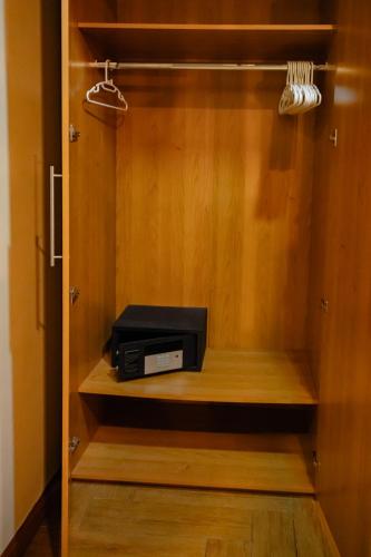 a wooden cabinet with a radio in it at Metro Pratunam Boutique Hotel in Pratunam
