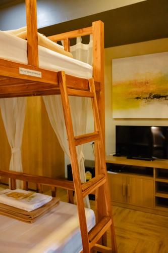 a bunk bed in a room with a ladder at Metro Pratunam Boutique Hotel in Pratunam