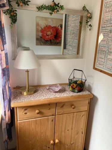 a lamp on top of a dresser in a room at Willstein in Bad Berleburg