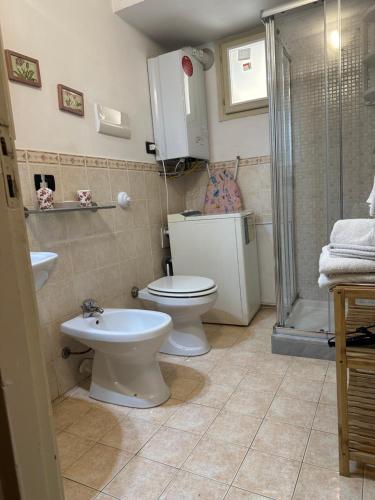 a bathroom with a toilet and a sink and a shower at VUCCIRIA 57 locazione turistica nel cuore pulsante della movida! in Palermo