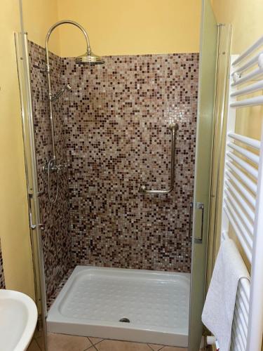 a bathroom with a shower with a tub and a sink at La Dodicesima Luna in Triuggio