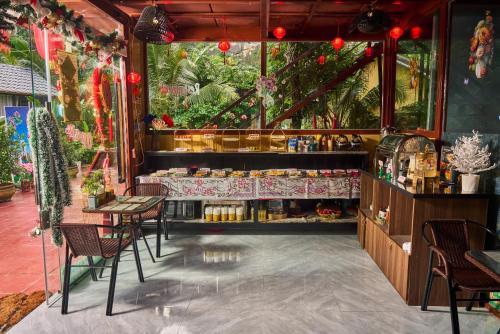 a restaurant with a counter with chairs and a table at Hoang Minh Mountainside Villa in Ninh Binh