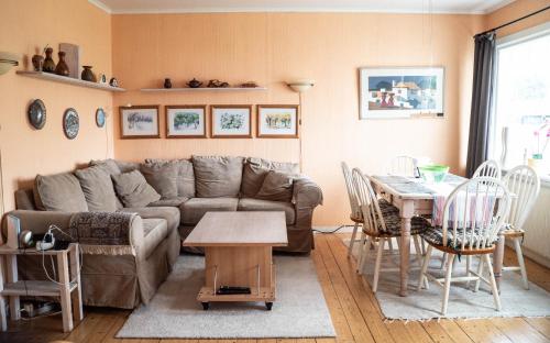 a living room with a couch and a table at Charming Villa in Stockholm in Herräng