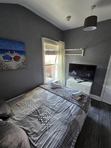 a bedroom with a bed and a large window at The Lynbar Hotel in Blackpool
