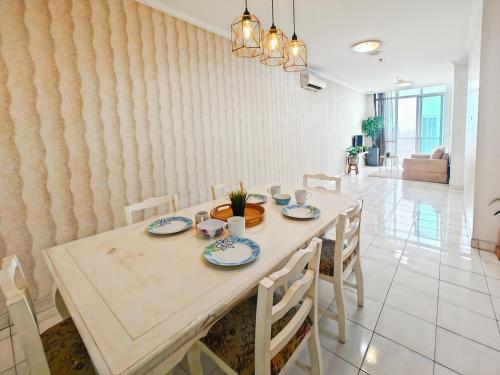 a dining room with a table and chairs at Large 2BR Ambassador 2 Apt Pool, Gym, WiFi in Jakarta