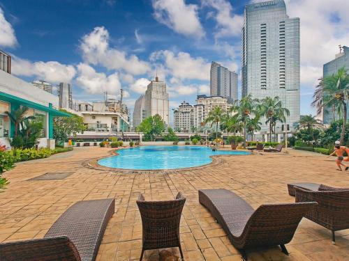 a swimming pool in the middle of a city at Large 2BR Ambassador 2 Apt Pool, Gym, WiFi in Jakarta