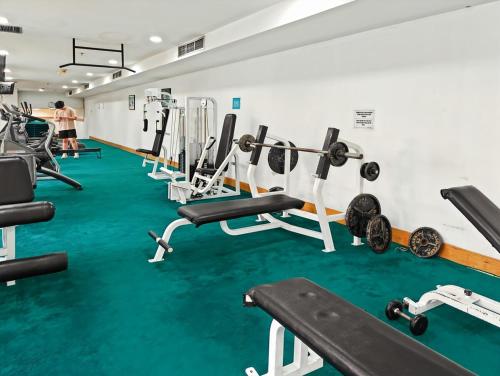 a gym with several treadmills and machines at Large 2BR Ambassador 2 Apt Pool, Gym, WiFi in Jakarta