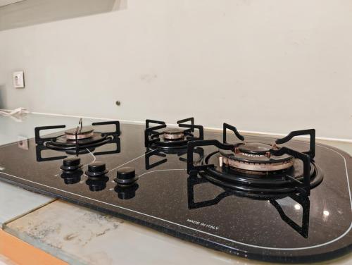 a stove top with three burners on top of it at Large 2BR Ambassador 2 Apt Pool, Gym, WiFi in Jakarta