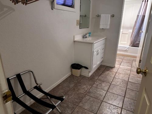 a bathroom with a sink and a chair in it at Seahorse Oceanfront Lodge in Lincoln City