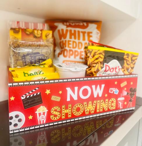 a shelf with a box of popcorn and other snacks at Guesthouse w Bikes near Wynwood in Miami