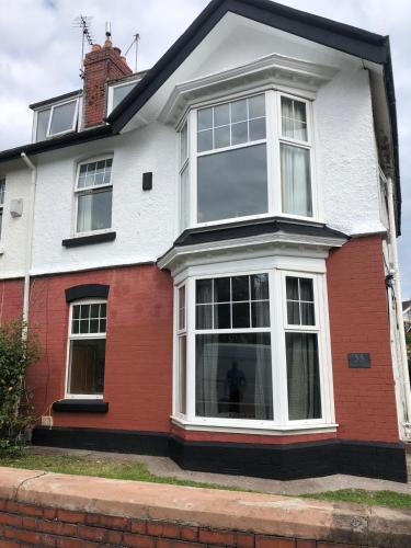 a red and white house with large windows at 55 Studio 4 Uplands in Swansea
