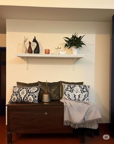 a shelf above a bed with pillows on a wall at MyYearlyStay in Udupi - Colonial in Udupi
