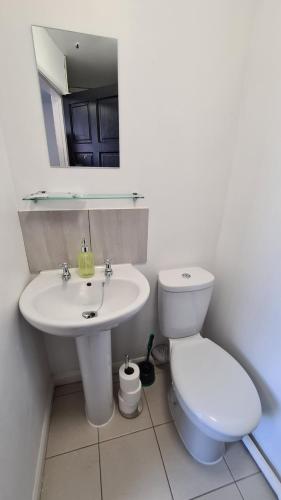 a white bathroom with a sink and a toilet at Moorfield View in Banbury