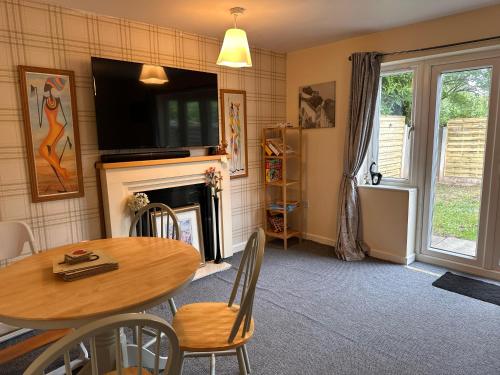 a dining room with a table and a fireplace at 3 Bed Entire House - Runcorn in Runcorn